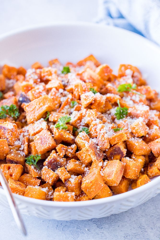 Close up of a bowl of Parmesan Roasted Sweet Potatoes