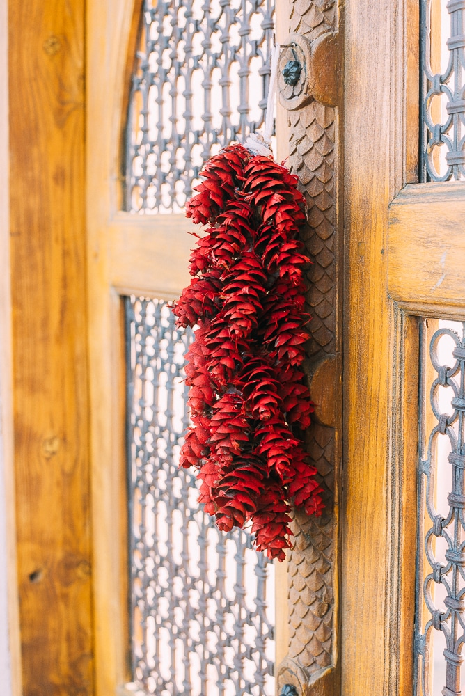 pinecone ristra hanging on a door